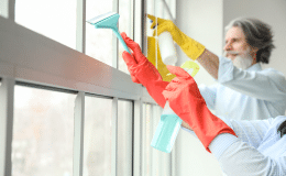 9b072699-mature-couple-cleaning-window-their-flat-1.png